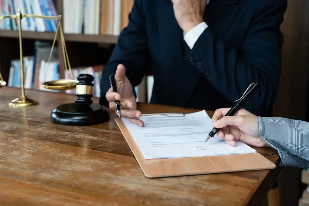 Attorney reviewing a probate document with a client at a desk in a Harris County law office