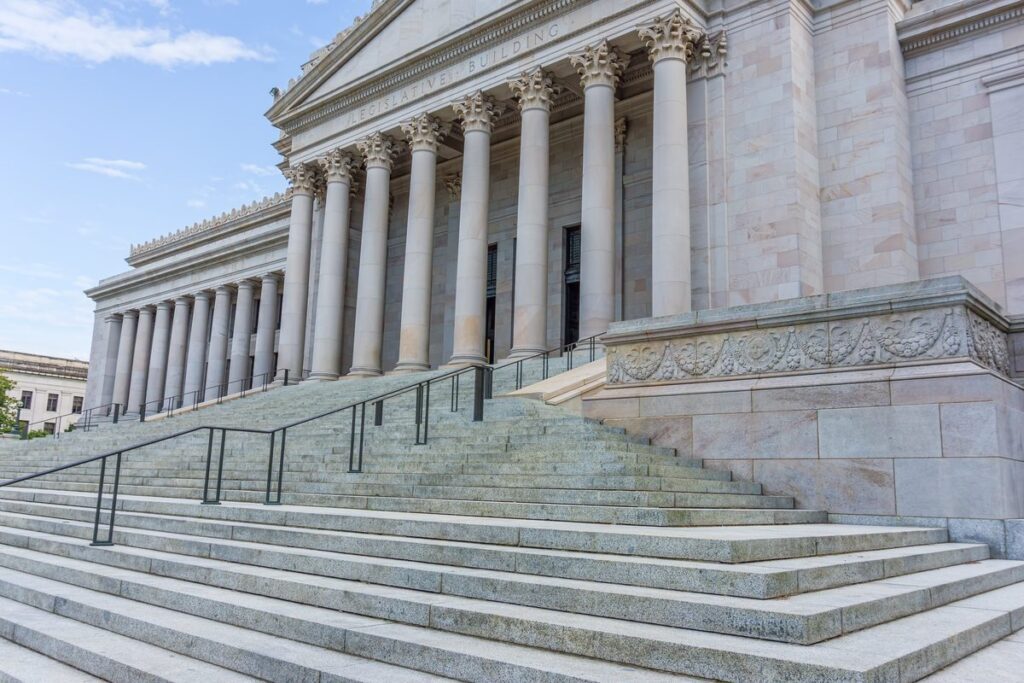 Stone steps leading up to the columned entrance of a courthouse
