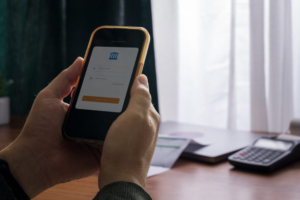 Person signing in to a banking app on a smartphone, one of the online accounts an executor may need access to