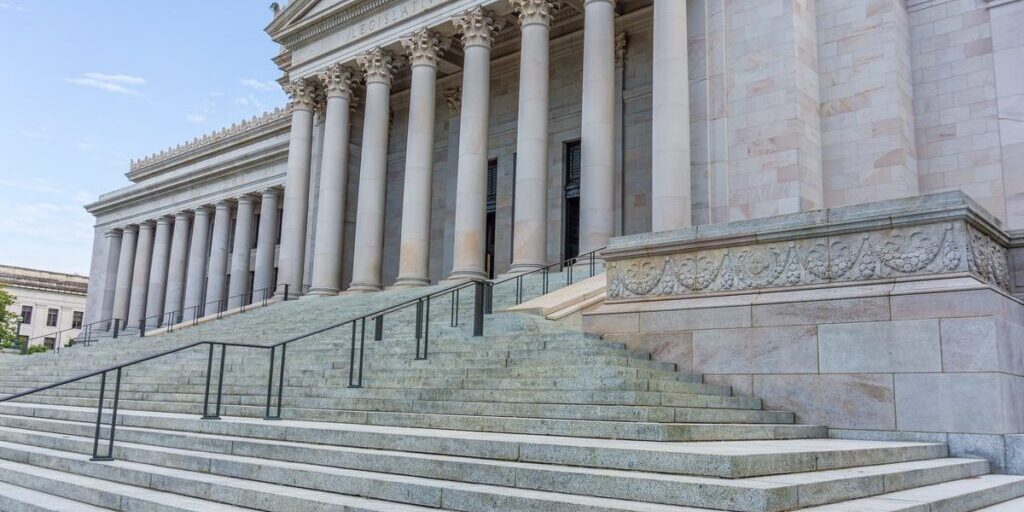 Stone steps leading up to the columned entrance of a courthouse